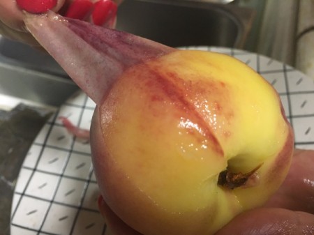 Removing the peel of a peach.
