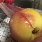 Removing the peel of a peach.