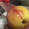 Removing the peel of a peach.