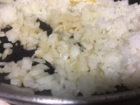 Rice and onions in pan