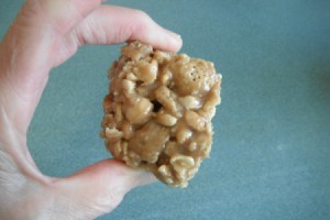 Hand held piece of No-Bake Peanut Butter Caramel Crunch