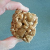 Hand held piece of No-Bake Peanut Butter Caramel Crunch