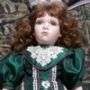 Identifying a Porcelain Doll - doll with red hair and wearing a green satin dress