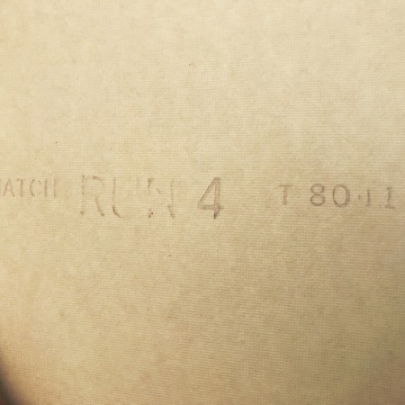 The markings on the back of a roll of wallpaper.