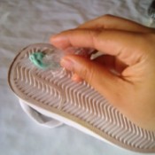 Rubbing ice on gum stuck to the bottom of a shoe.