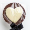 A chocolate lollipop with a white chocolate heart.