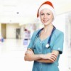 A female healthcare worker wearing a santa hat.