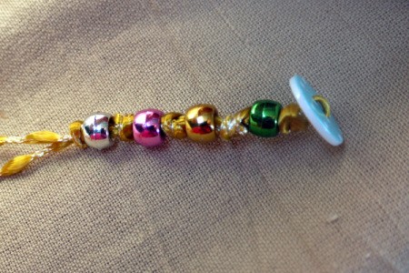 Button and Bead Knotted Bracelet - continue adding beads and knots until it fits around your wrist