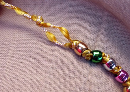 Button and Bead Knotted Bracelet - tie a final knot leaving enough space to push the button through with a bit of a push
