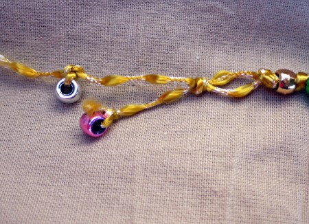 Button and Bead Knotted Bracelet - tie beads onto the ends of the cord