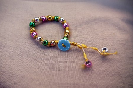 Button and Bead Knotted Bracelet - - fasten the bracelet using the button