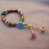 Button and Bead Knotted Bracelet - - fasten the bracelet using the button