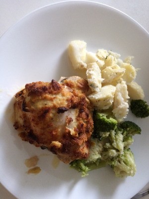 Hummus-Crusted Chickenon dinner plate with broccoli and potatoes