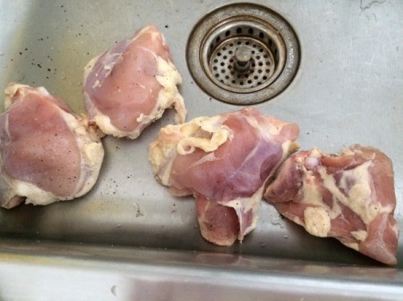 chicken thighs in sink