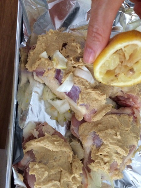squeezing lemon on Chicken