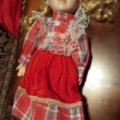Identifying a Porcelain Doll - blond haired doll wearing a long plaid dress