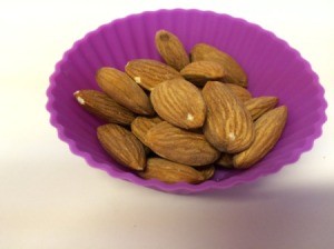 A portion of almonds in a silicone muffin cup.