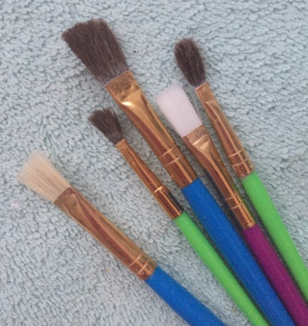 A collection of paint brushes of different sizes.