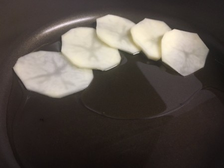 potato slices in pan