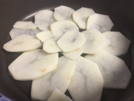 potato slices in pan