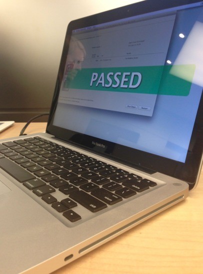 An Apple MacBook Pro laptop computer that says "Passed" on the screen.
