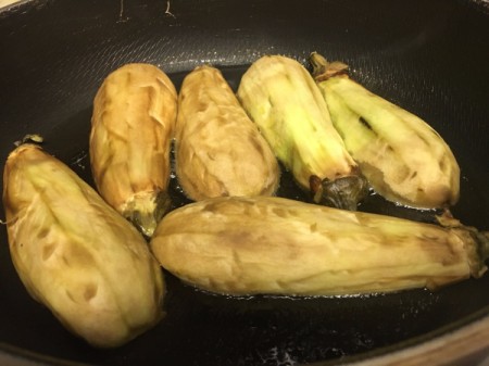 peeled eggplant in pan