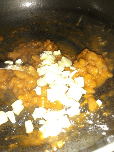 cheese added to beans in pan