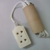 An extension cord tucked into a recycled tissue roll.