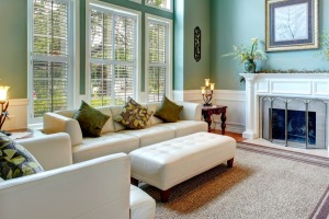 A living room with lots of windows and a fire place.