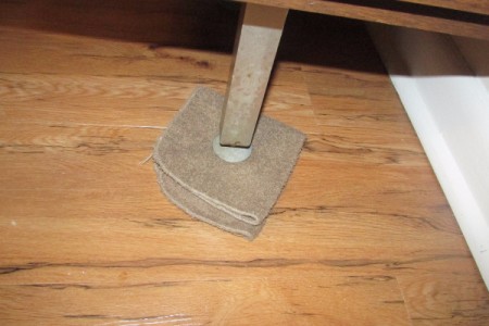 A washcloth under the leg of a heavy piece of furniture, to assist in moving it.