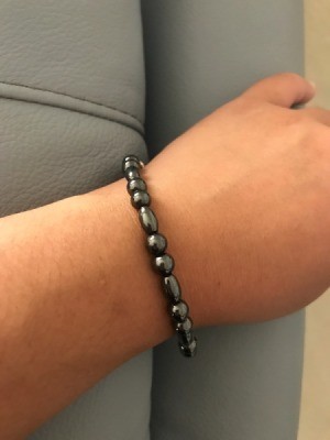 A unisex magnetic bracelet on a wrist.