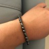 A unisex magnetic bracelet on a wrist.