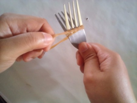 Two forks connected with a rubber band to use as tongs.