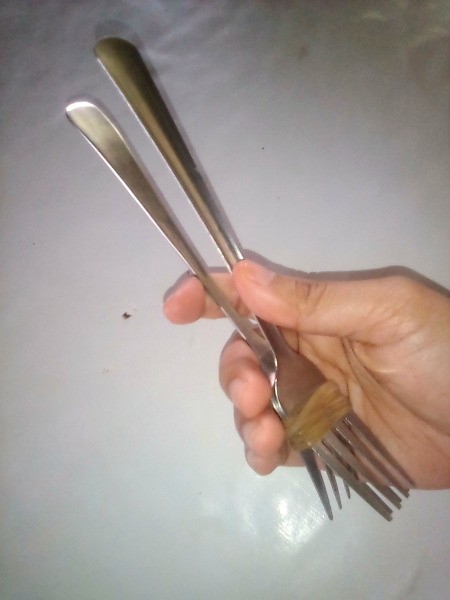 Two forks connected with a rubber band to use as tongs.