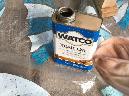 Refinishing Teak Outdoor Furniture - can of teak oil and cloth