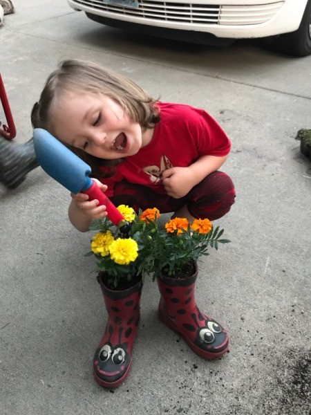 Rubber Boot Planter - little boy admiring his planted boots