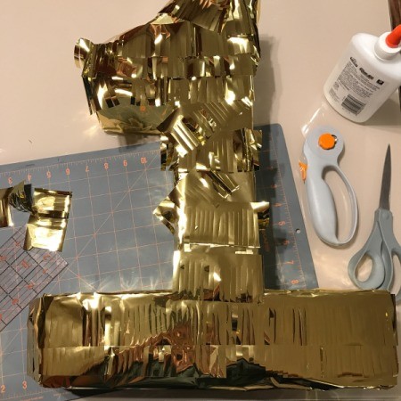 Birthday Number Piñata - continue adding fringe and gluing in place partially covered at top