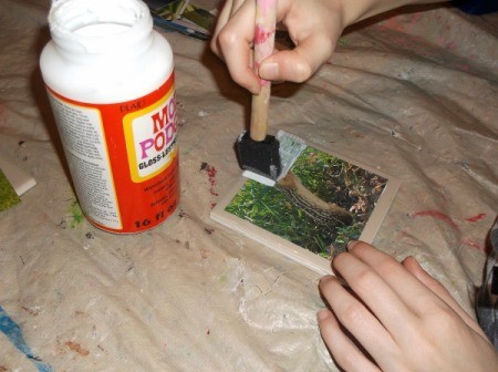 Picture Tile Coasters - painting a coat of mod podge on picture