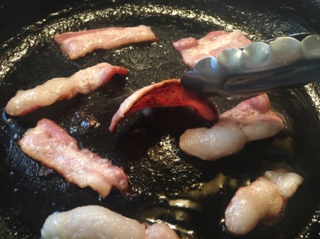 cooking bacon in a fry pan