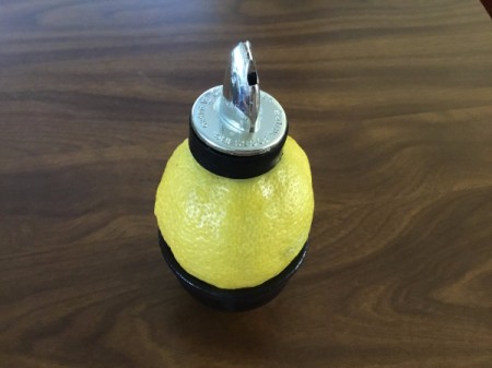 Using a oil bottle dispenser to juice a lemon.