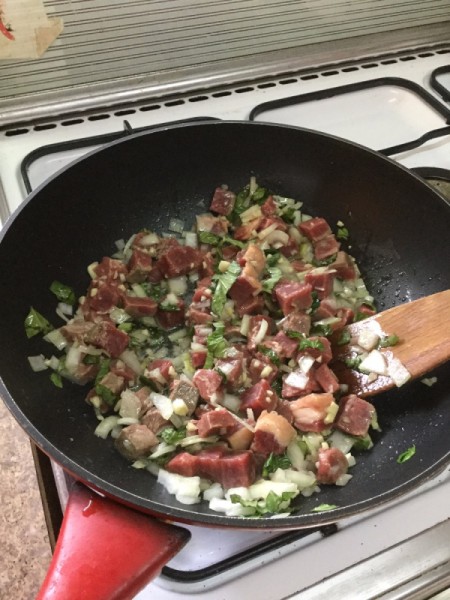 cooking steak and vegetables in wok
