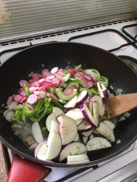 adding eggplant to wok