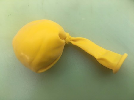 DIY Makeup Beauty Blender - shape dough into a semi flattened disc inside the balloon and tie a knot