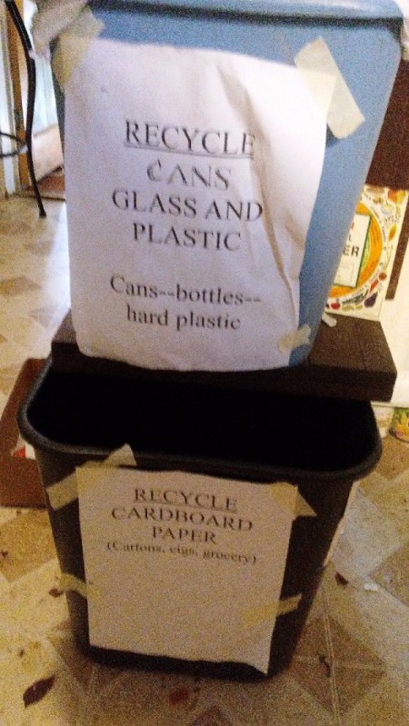 Signs for where to recycle cans, glass, plastic and cardboard.