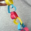 Heart Shaped Paper Chain - hand holding a short length of heart shaped paper chain links, connected