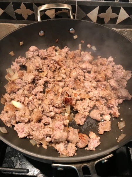 sausage and onion cooked in pan