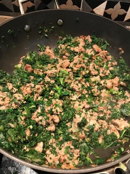 cooked spinach, kale, sausage and onion in pan