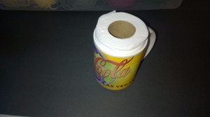 A partially used roll of toilet paper inside a mug for shipping.