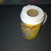 A partially used roll of toilet paper inside a mug for shipping.