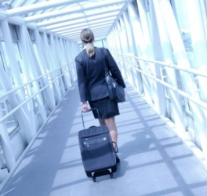 A flight attendant talking at the airport.